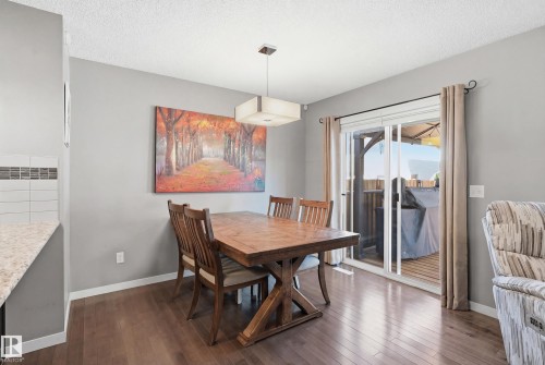 Dining space featuring dark wood-style flooring and a textured ceiling - 2031 Westerra Loop, Stony Plain, AB - Indoor Photo Showing Dining Room