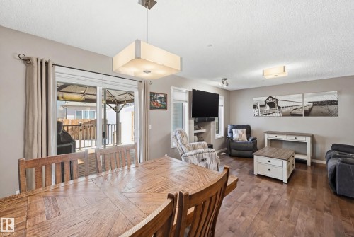 Dining room with wood finished floors and a textured ceiling - 2031 Westerra Loop, Stony Plain, AB - Indoor