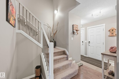 Foyer entrance with light wood-style flooring and a textured ceiling - 2031 Westerra Loop, Stony Plain, AB - Indoor Photo Showing Other Room