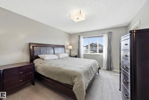 Bedroom featuring light colored carpet and a textured ceiling - 2031 Westerra Loop, Stony Plain, AB - Indoor Photo Showing Bedroom