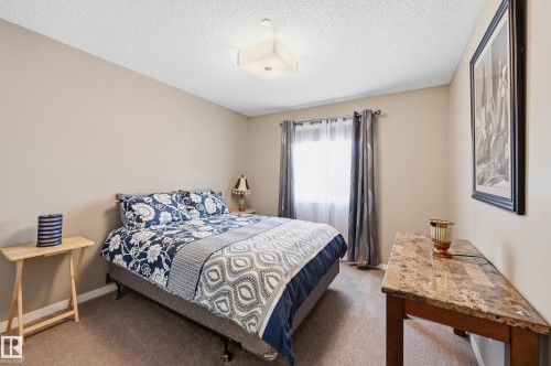 Carpeted bedroom with a textured ceiling and baseboards - 2031 Westerra Loop, Stony Plain, AB - Indoor Photo Showing Bedroom