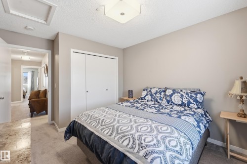 Bedroom featuring a closet, a textured ceiling, and light colored carpet - 2031 Westerra Loop, Stony Plain, AB - Indoor Photo Showing Bedroom