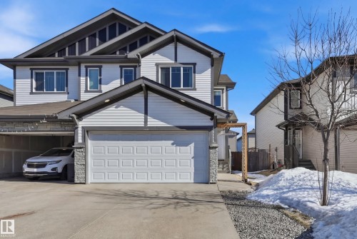 View of front of property with concrete driveway, stone siding, and an attached garage - 2031 Westerra Loop, Stony Plain, AB - Outdoor