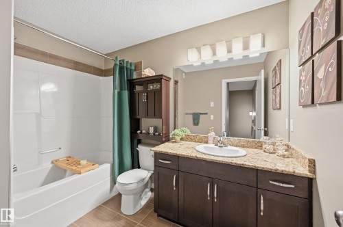 Bathroom with vanity, shower / bathtub combination with curtain, and a textured ceiling - 2031 Westerra Loop, Stony Plain, AB - Indoor Photo Showing Bathroom