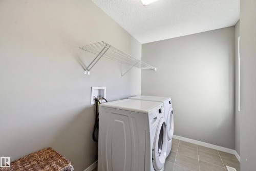 Laundry area featuring a textured ceiling and separate washer and dryer - 2031 Westerra Loop, Stony Plain, AB - Indoor Photo Showing Laundry Room