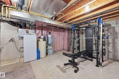 Exercise area with concrete flooring and water heater - 2031 Westerra Loop, Stony Plain, AB - Indoor Photo Showing Basement