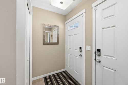 Foyer with a textured ceiling and baseboards - 2031 Westerra Loop, Stony Plain, AB - Indoor Photo Showing Other Room