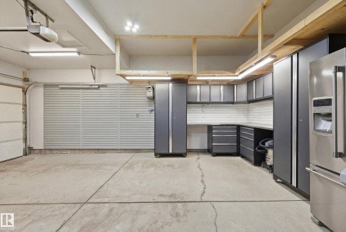 Garage featuring high quality fridge and a garage door opener - 2031 Westerra Loop, Stony Plain, AB - Indoor Photo Showing Garage