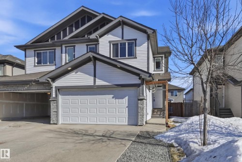 View of front of home featuring concrete driveway, entry steps, and stone siding - 2031 Westerra Loop, Stony Plain, AB - Outdoor With Facade