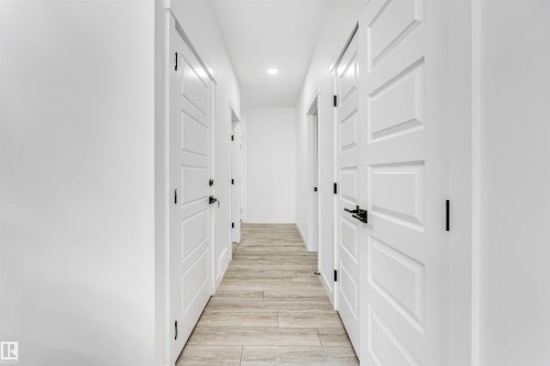 Corridor with light wood-type flooring and recessed lighting - 2629 15A Avenue, Edmonton, AB - Indoor Photo Showing Other Room