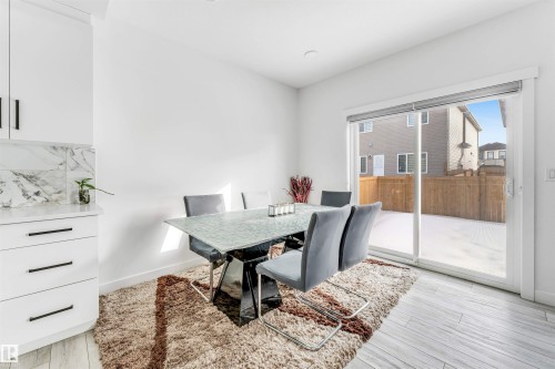 Dining space with light wood-type flooring and baseboards - 2629 15A Avenue, Edmonton, AB - Indoor Photo Showing Dining Room