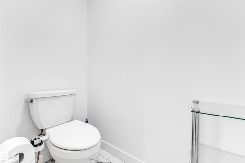 Bathroom with toilet and baseboards - 2629 15A Avenue, Edmonton, AB - Indoor Photo Showing Bathroom