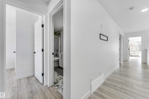 Hallway featuring light wood-type flooring and baseboards - 2629 15A Avenue, Edmonton, AB - Indoor Photo Showing Other Room