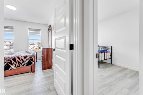 Hall with light wood-style floors and baseboards - 2629 15A Avenue, Edmonton, AB - Indoor