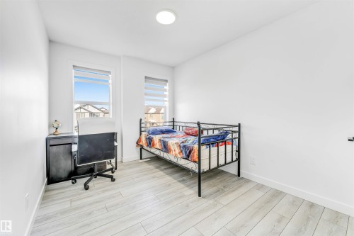 Bedroom with light wood-style floors and baseboards - 2629 15A Avenue, Edmonton, AB - Indoor Photo Showing Bedroom