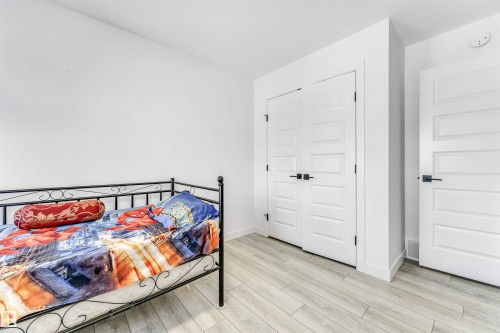 Bedroom featuring light wood-type flooring and a closet - 2629 15A Avenue, Edmonton, AB - Indoor Photo Showing Bedroom