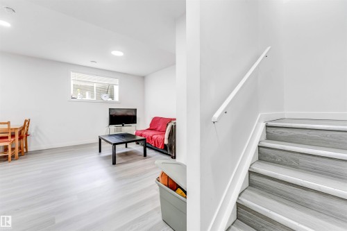 Stairway with wood finished floors and recessed lighting - 2629 15A Avenue, Edmonton, AB - Indoor Photo Showing Other Room