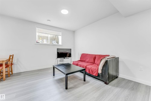 Living area featuring light wood-type flooring and baseboards - 2629 15A Avenue, Edmonton, AB - Indoor Photo Showing Living Room
