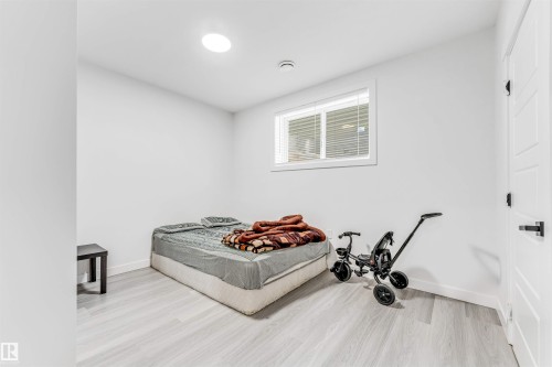 Bedroom featuring light wood-style floors and baseboards - 2629 15A Avenue, Edmonton, AB - Indoor Photo Showing Bedroom