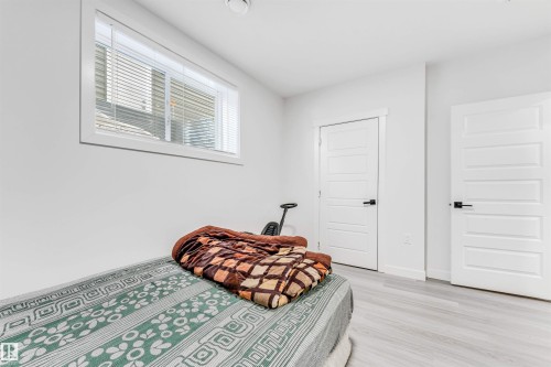 Bedroom featuring baseboards and light wood-style flooring - 2629 15A Avenue, Edmonton, AB - Indoor Photo Showing Bedroom