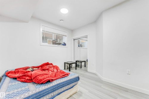 Bedroom with light wood finished floors and a closet - 2629 15A Avenue, Edmonton, AB - Indoor Photo Showing Bedroom