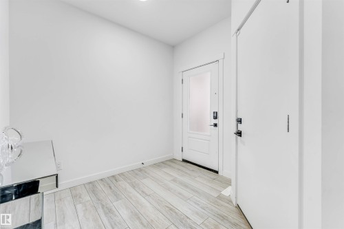 Doorway with wood finished floors and baseboards - 2629 15A Avenue, Edmonton, AB - Indoor Photo Showing Other Room