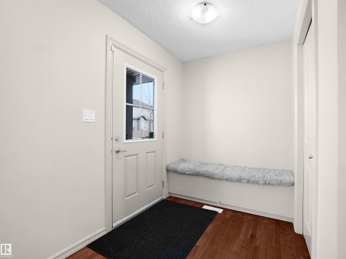 Doorway featuring wood finished floors and a textured ceiling - 1708 62 Street, Edmonton, AB - Indoor Photo Showing Other Room