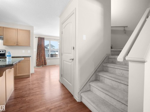 Stairway with wood finished floors and a textured ceiling - 1708 62 Street, Edmonton, AB - Indoor