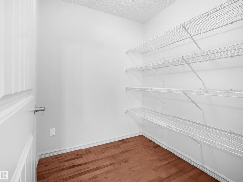 Walk in closet with dark wood-style flooring - 1708 62 Street, Edmonton, AB - Indoor With Storage