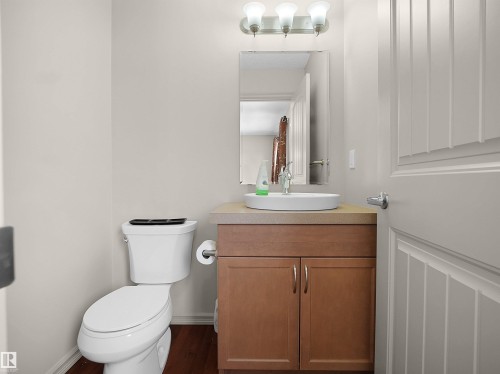 Half bath with vanity and dark wood-style floors - 1708 62 Street, Edmonton, AB - Indoor Photo Showing Bathroom