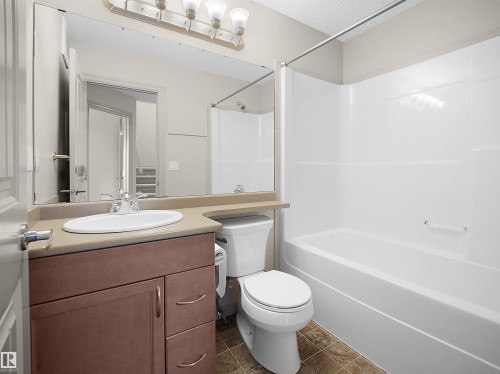 Full bath featuring vanity, shower / washtub combination, and a textured ceiling - 1708 62 Street, Edmonton, AB - Indoor Photo Showing Bathroom