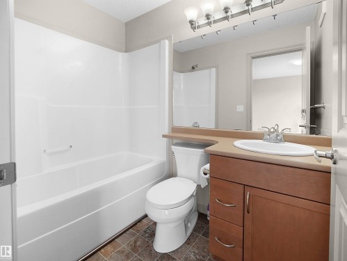 Bathroom featuring vanity, shower / bathtub combination, and a textured ceiling - 1708 62 Street, Edmonton, AB - Indoor Photo Showing Bathroom