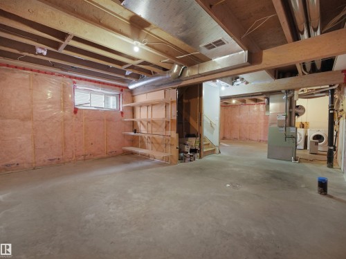Basement featuring heating unit and separate washer and dryer - 1708 62 Street, Edmonton, AB - Indoor Photo Showing Basement