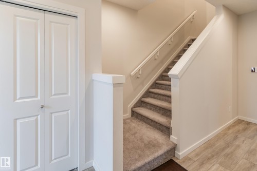 Stairway featuring baseboards and wood finished floors - 304 36 Avenue, Edmonton, AB - Indoor Photo Showing Other Room