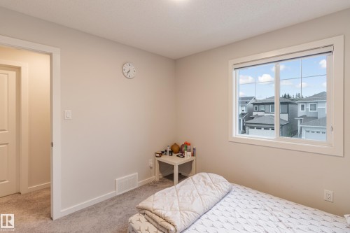 Bedroom with light carpet and baseboards - 304 36 Avenue, Edmonton, AB - Indoor Photo Showing Bedroom