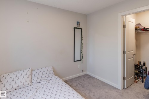 Bedroom with a walk in closet and light carpet - 304 36 Avenue, Edmonton, AB - Indoor Photo Showing Bedroom