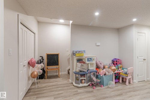 Rec room featuring recessed lighting, light wood finished floors, and a textured ceiling - 304 36 Avenue, Edmonton, AB - Indoor Photo Showing Basement