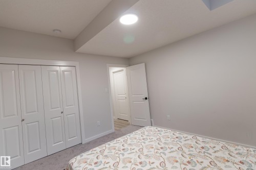 Bedroom with a closet and light colored carpet - 304 36 Avenue, Edmonton, AB - Indoor Photo Showing Bedroom