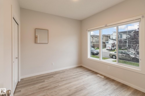 Empty room featuring light wood-style floors and baseboards - 304 36 Avenue, Edmonton, AB - Indoor Photo Showing Other Room