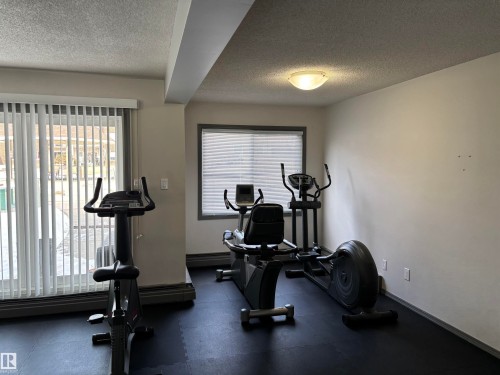 Dedicated fitness area featuring rubber mat flooring - 207 11465 41 Avenue, Edmonton, AB - Indoor Photo Showing Gym Room