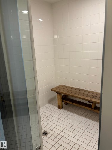 Spacious shower enclosure featuring white subway tile walls and a coordinating white tile floor - 207 11465 41 Avenue, Edmonton, AB - Indoor Photo Showing Bathroom