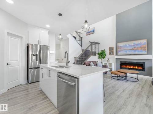111 Bluff Cove, Leduc, AB - Indoor Photo Showing Kitchen With Fireplace With Double Sink With Upgraded Kitchen