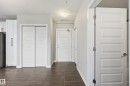 Hall with a textured ceiling and baseboards - 511 5151 Windermere Boulevard, Edmonton, AB  - Indoor Photo Showing Other Room 