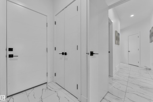 Hallway featuring light marble finish flooring and recessed lighting - 16812 48 Street Nw, Edmonton, AB - Indoor Photo Showing Other Room