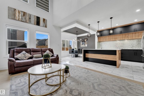 Living room with suspended lighting and a high ceiling - 16812 48 Street Nw, Edmonton, AB - Indoor Photo Showing Living Room
