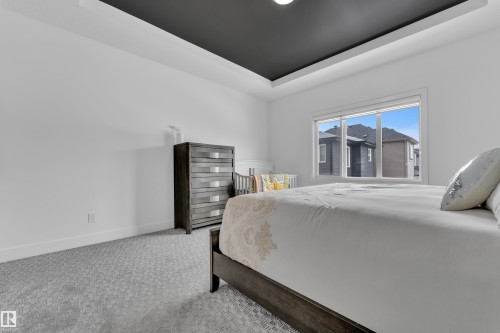 Bedroom featuring carpet floors and a raised ceiling - 16812 48 Street Nw, Edmonton, AB - Indoor Photo Showing Bedroom