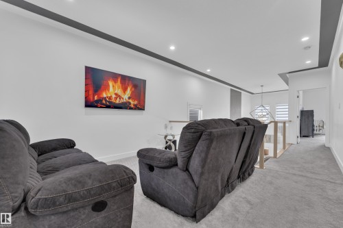 Home theater room with recessed lighting and light colored carpet - 16812 48 Street Nw, Edmonton, AB - Indoor Photo Showing Other Room