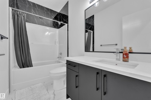 Bathroom with vanity and shower / tub combo - 16812 48 Street Nw, Edmonton, AB - Indoor Photo Showing Bathroom