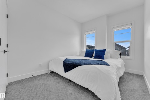 Bedroom featuring light carpet and baseboards - 16812 48 Street Nw, Edmonton, AB - Indoor Photo Showing Bedroom
