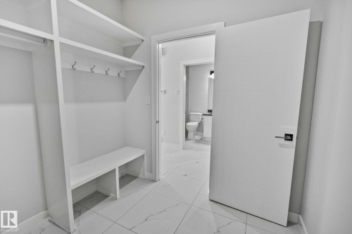 Mudroom with baseboards and light marble finish flooring - 3524 41 Ave, Beaumont, AB - Indoor With Storage
